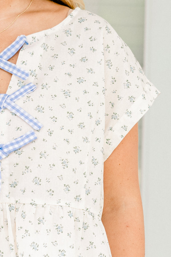 Chic Soul plus size clothing, white short sleeve top with blue small floral pint with blue gingham ties down the center