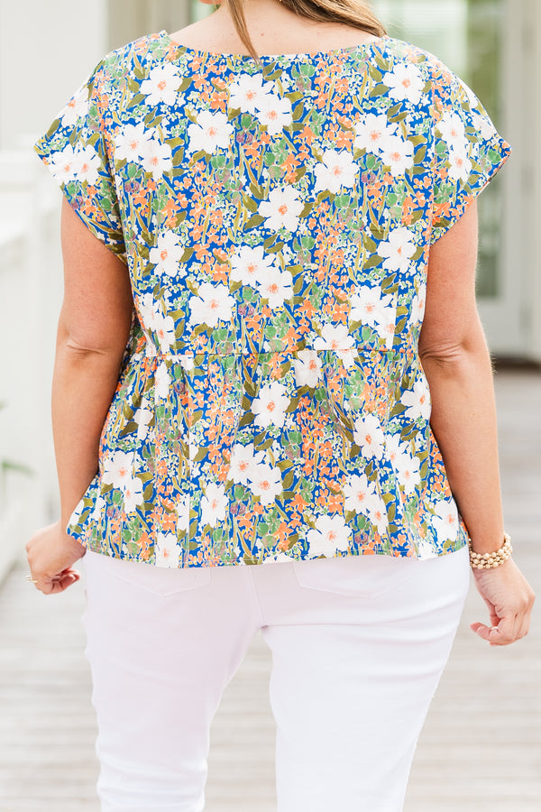 Chic Soul plus size clothing, short-sleeve green baby doll top with a high-scoop-neckline and three white bows tying the front with a green multi-colored floral pattern 