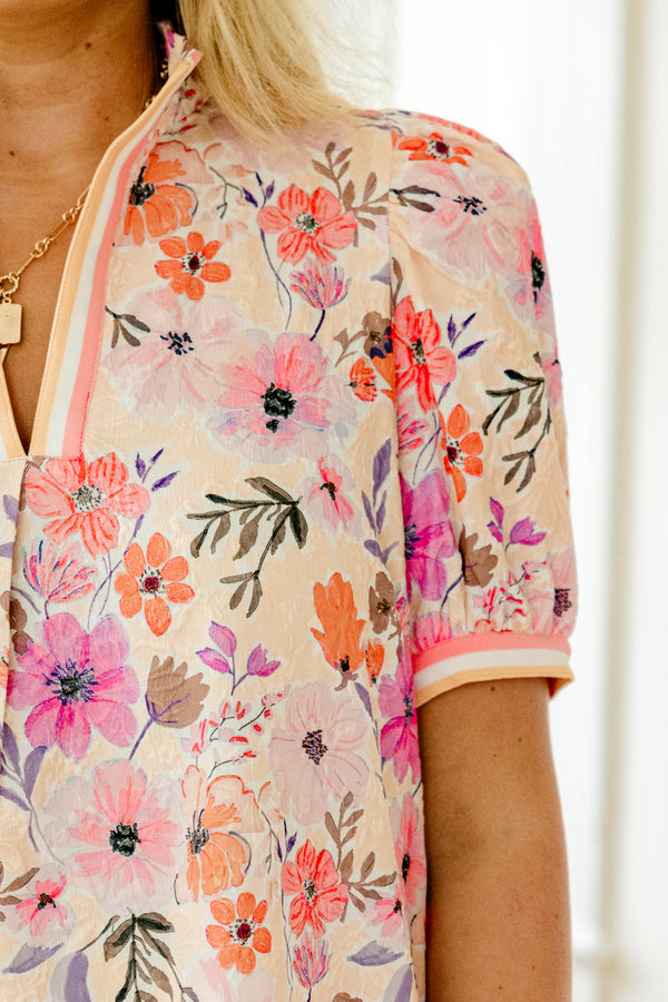 Chic Soul Plus size clothing, coral and peach blouse with a floral pattern and bubble sleeves that have a striped cuff at the end of the sleeves and along the v-neck
