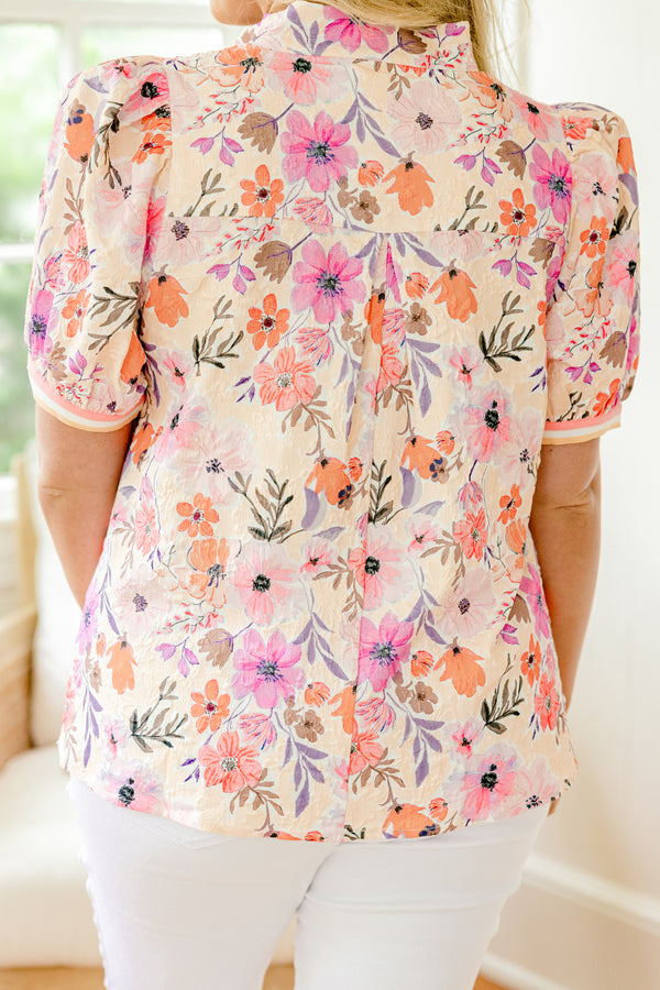Chic Soul Plus size clothing, coral and peach blouse with a floral pattern and bubble sleeves that have a striped cuff at the end of the sleeves and along the v-neck
