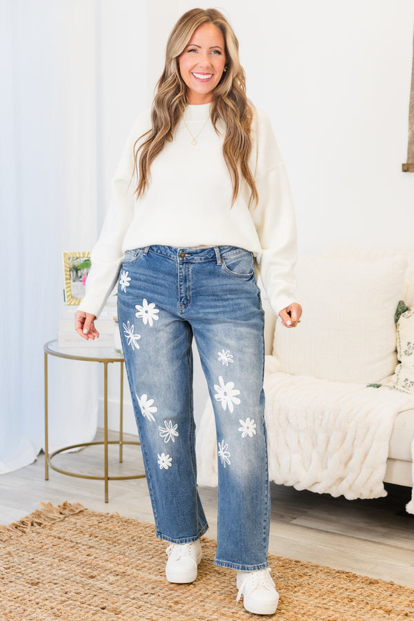 Chic Soul plus size clothing, mid-waisted medium wash denim mom jeans with white flower decals scattered along the front of the jeans