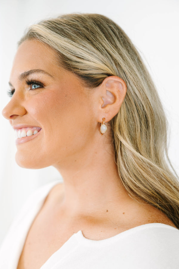 Plus Size gold drop earrings with a smooth, oval white stone inlay.