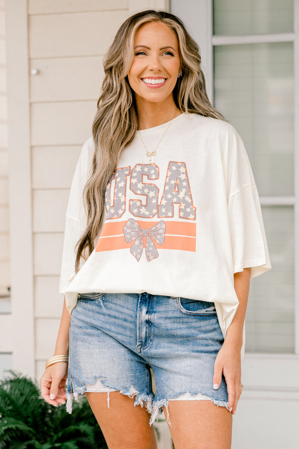 Plus Size ivory oversized boyfriend tee with a USA and bow graphic in a patriotic star pattern.
