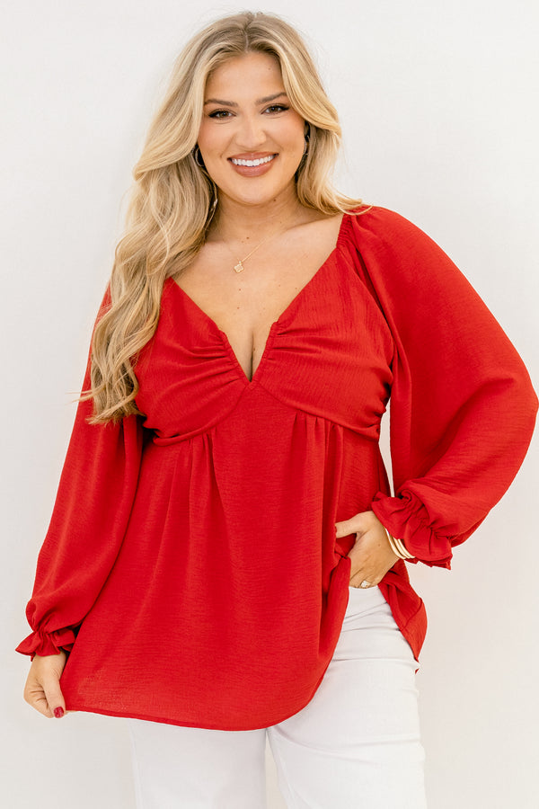 Plus Size red v-neck top with elastic balloon sleeves and a smocked back in a textured fabric.
