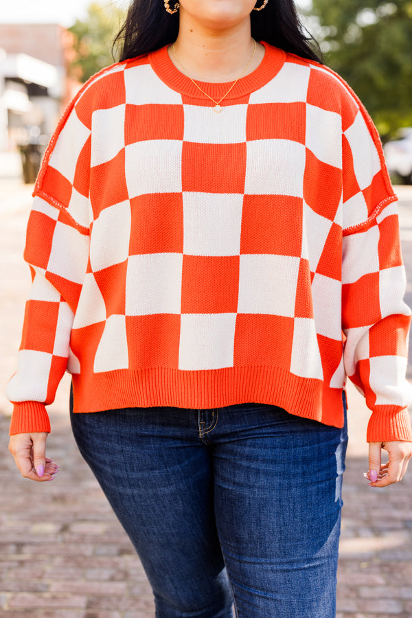 long-sleeve orange and cream checkered sweater with crew neckline and subtly distressed stitching