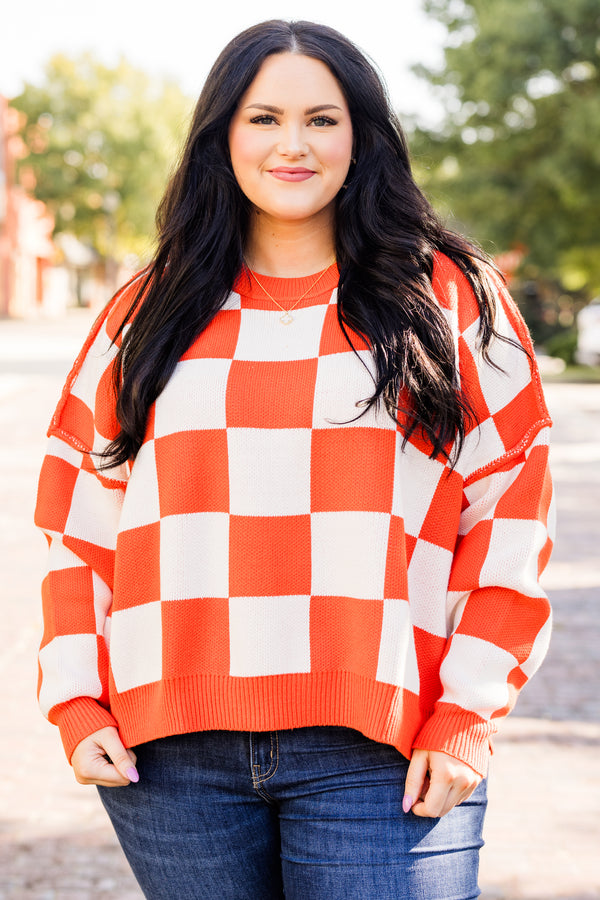 long-sleeve orange and cream checkered sweater with crew neckline and subtly distressed stitching