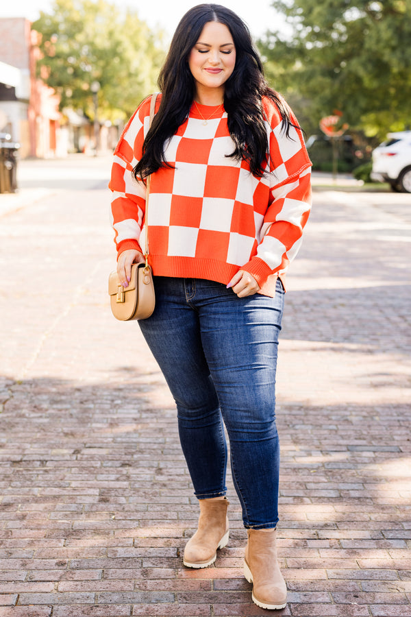 long-sleeve orange and cream checkered sweater with crew neckline and subtly distressed stitching