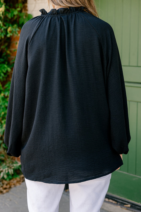 Chic Soul Plus size clothing, black solid colored blouse with long bubble sleeves and ruffle details on the neckline and down the cent of the shirt 
