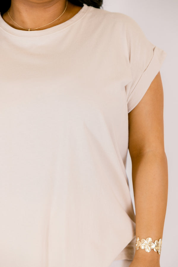 Plus Size sand beige 100% cotton crew neck tee with cuffed short sleeves and white pants.