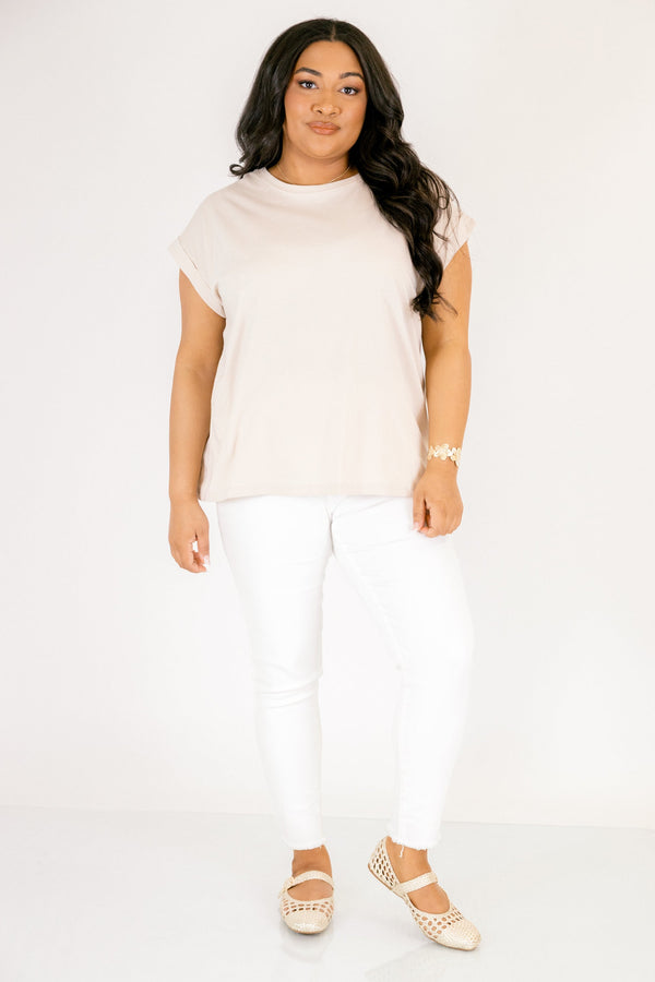 Plus Size sand beige 100% cotton crew neck tee with cuffed short sleeves and white pants.