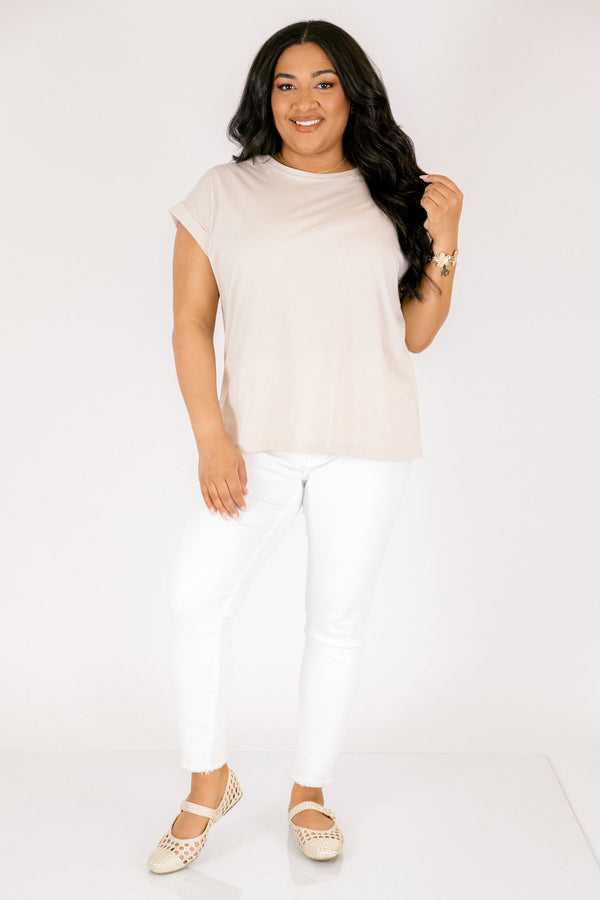 Plus Size sand beige 100% cotton crew neck tee with cuffed short sleeves and white pants.