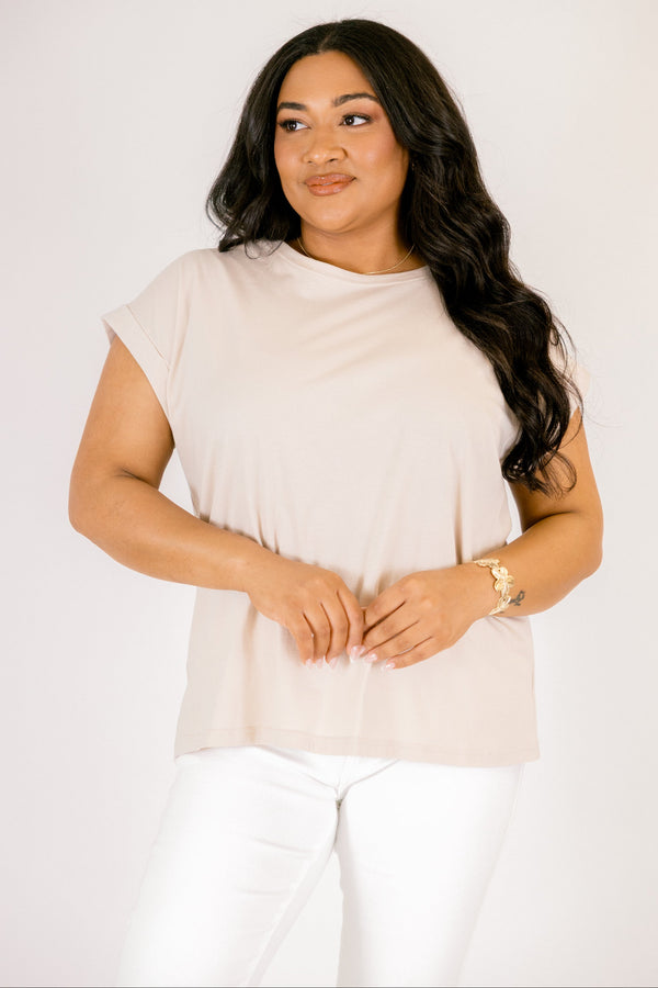 Plus Size sand beige 100% cotton crew neck tee with cuffed short sleeves and white pants.