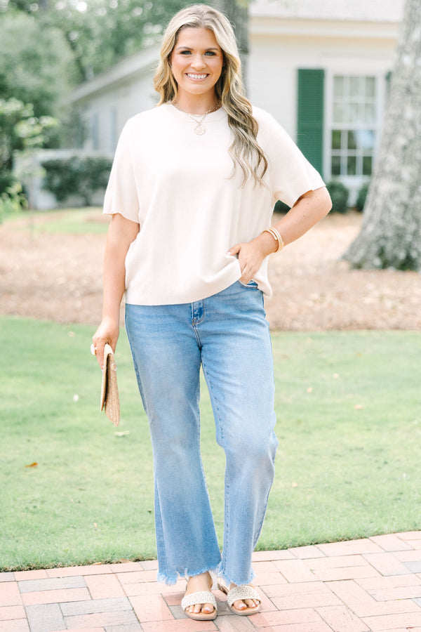 Plus Size light taupe short sleeve knit sweater with a crew neckline and ribbed trim.