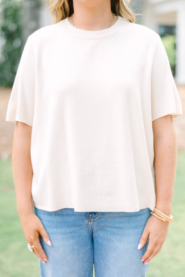 Plus Size light taupe short sleeve knit sweater with a crew neckline and ribbed trim.