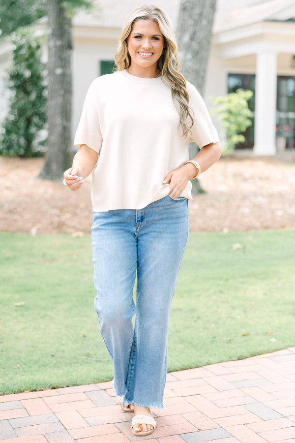 Plus Size light taupe short sleeve knit sweater with a crew neckline and ribbed trim.