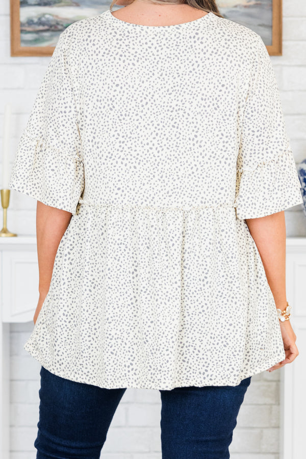 Chic Soul plus size clothing, ivory-grey short sleeve babydoll top with ruffle detail on sleeves and round neckline with ruffle along waist with small dotted print