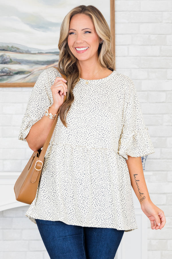 Chic Soul plus size clothing, ivory-grey short sleeve babydoll top with ruffle detail on sleeves and round neckline with ruffle along waist with small dotted print