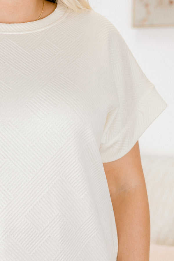 Chic Soul plus size clothing,  short-sleeve ivory top with a textured geometric pattern with subtle raised lines in a diagonal grid design and a high-scoop-neckline