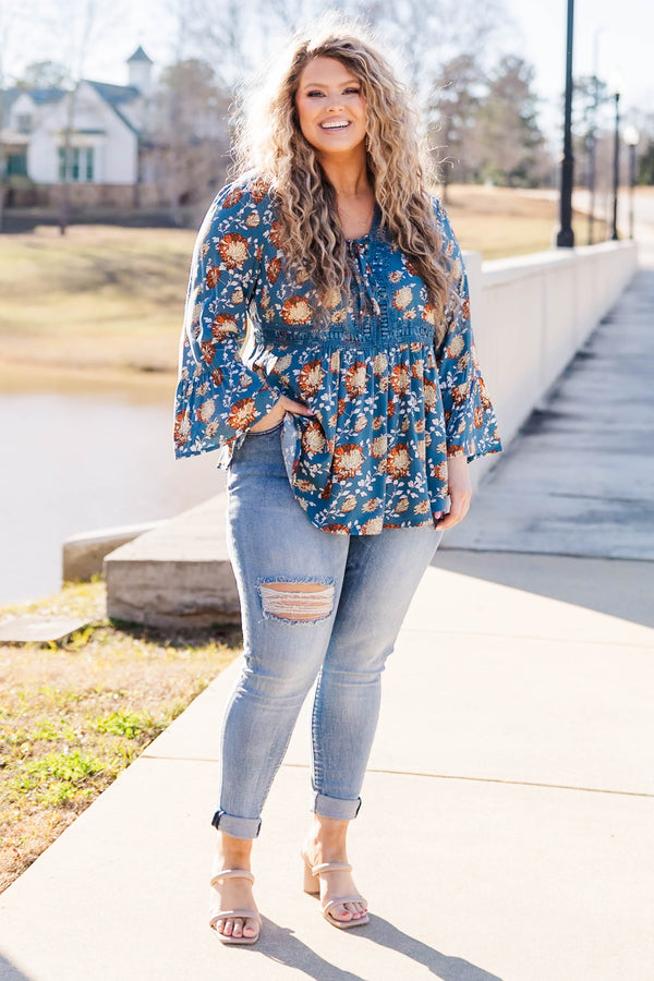 Chic Soul plus size clothing, blue flare sleeve long sleeve top with orange/ivory floral design with tie detail on neckline and lace along waist and collar