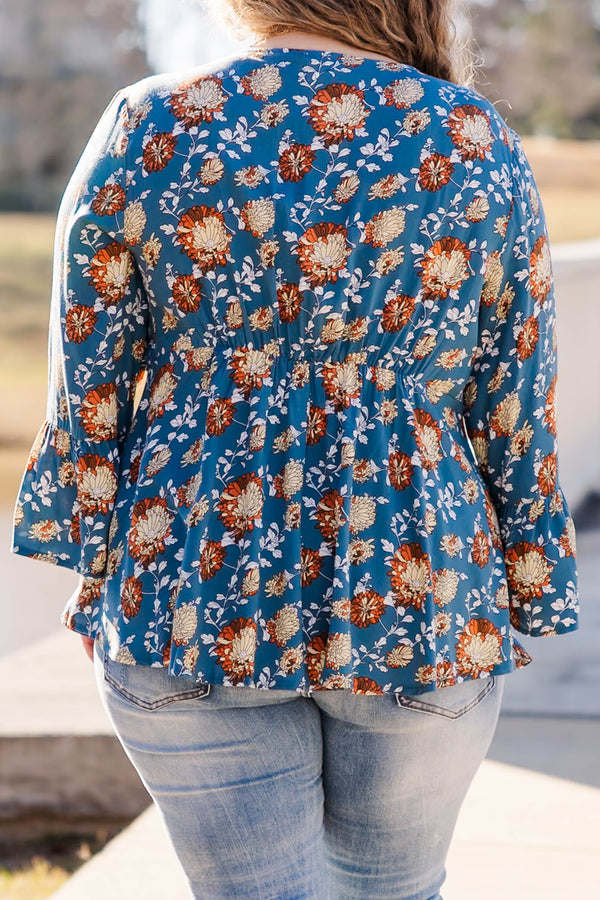 Chic Soul plus size clothing, blue flare sleeve long sleeve top with orange/ivory floral design with tie detail on neckline and lace along waist and collar