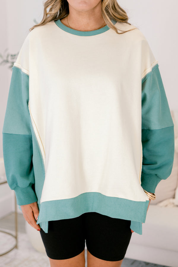 Chic Soul plus size clothing, cream long sleeve pullover over, with two different green accents on the sleeves as well as going along the sides and bottom of the pullover and across the neckline