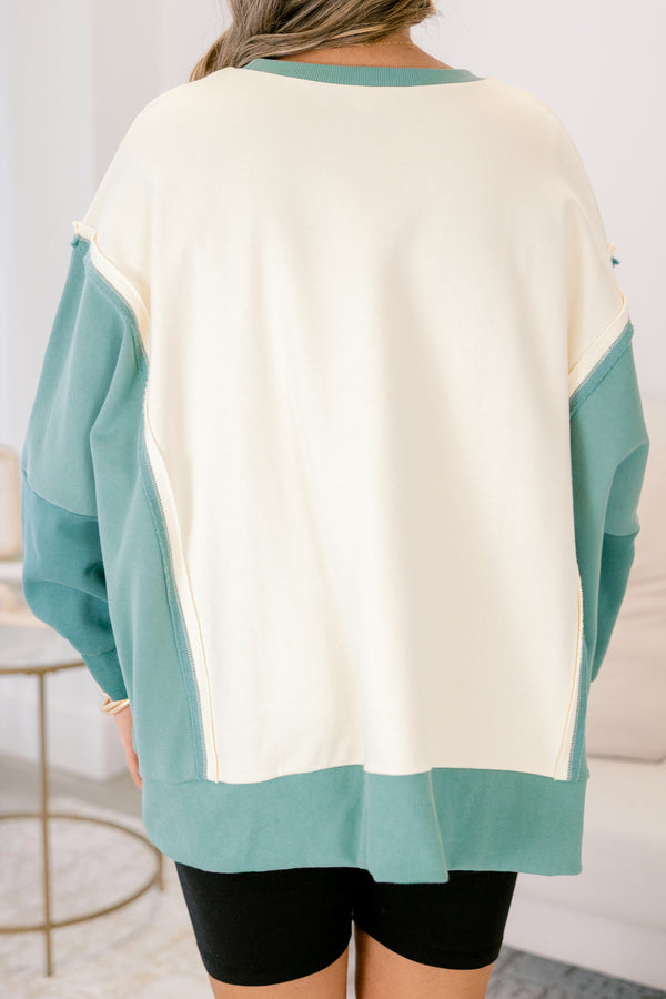 Chic Soul plus size clothing, cream long sleeve pullover over, with two different green accents on the sleeves as well as going along the sides and bottom of the pullover and across the neckline