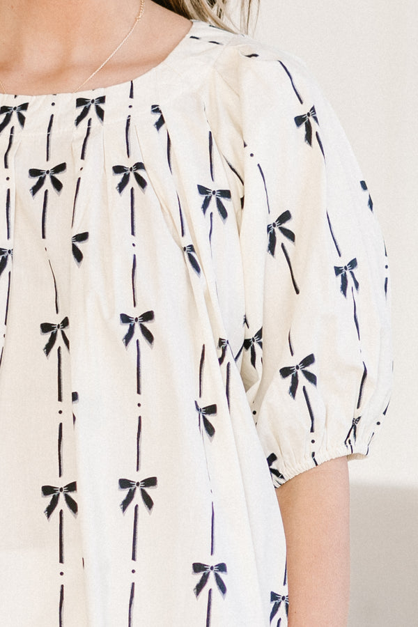 Chic Soul plus size clothing, ivory scoop neck short sleeve top with black bow design print with puff sleeves