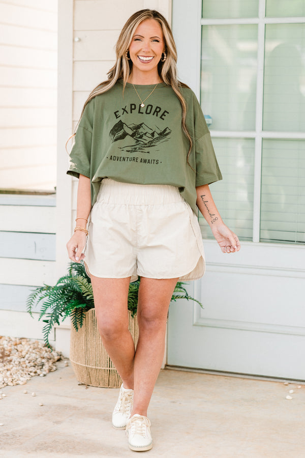 Plus Size bone-colored windbreaker shorts with a smocked waistband and slit hem.