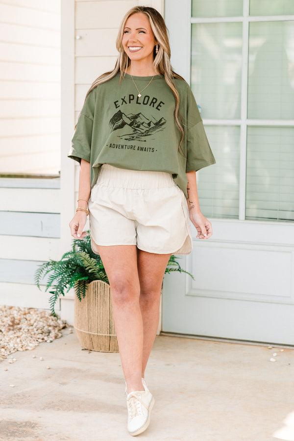 Plus Size bone-colored windbreaker shorts with a smocked waistband and slit hem.