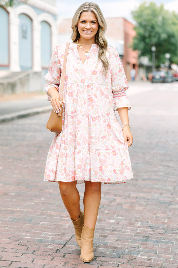 Plus Size pink floral mini dress with a split v-neck, tiered skirt, and smocked bell sleeves.