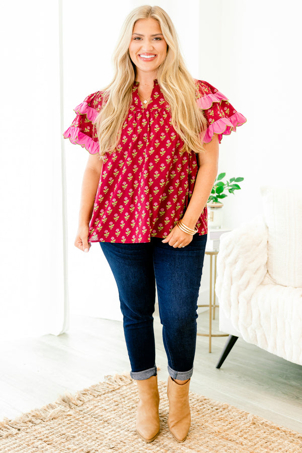 Chic Soul plus size clothing, red top with a floral pattern and flutter sleeves that have a pink ruffle at the end of each sleeve 