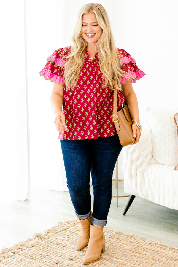 Chic Soul plus size clothing, red top with a floral pattern and flutter sleeves that have a pink ruffle at the end of each sleeve 