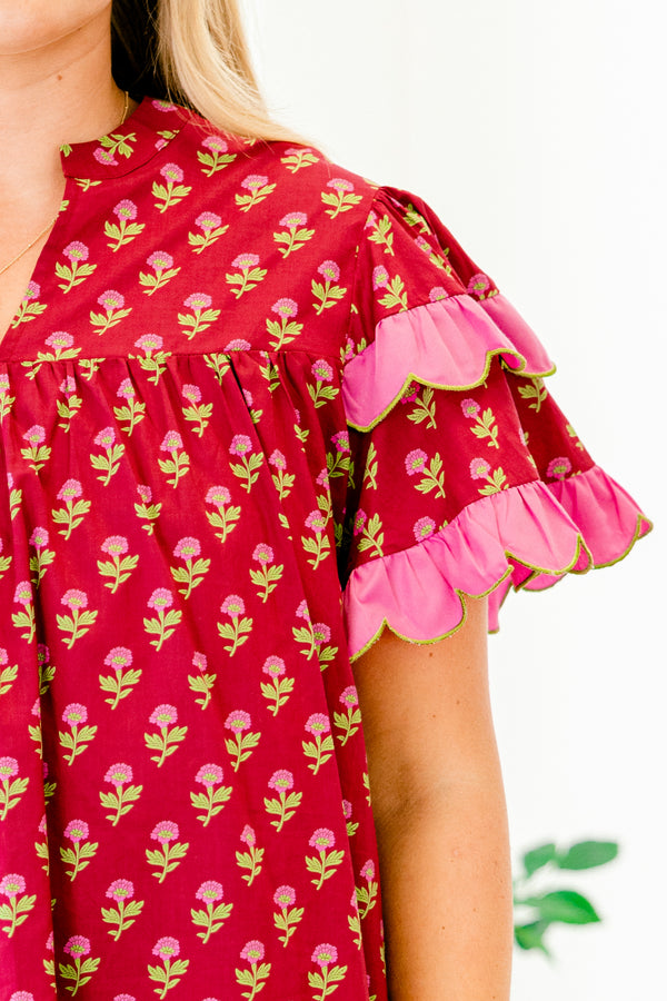 Chic Soul plus size clothing, red top with a floral pattern and flutter sleeves that have a pink ruffle at the end of each sleeve 