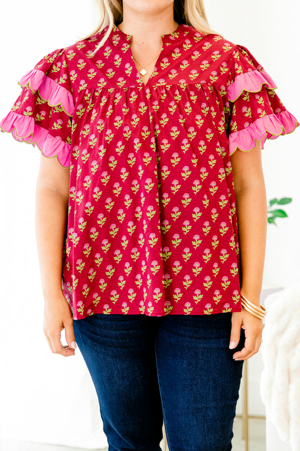 Chic Soul plus size clothing, red top with a floral pattern and flutter sleeves that have a pink ruffle at the end of each sleeve 