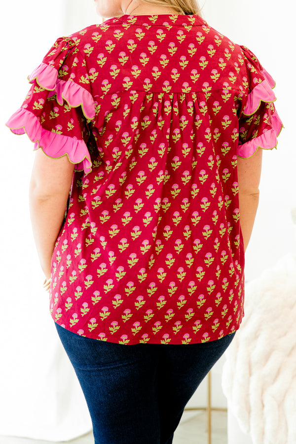 Chic Soul plus size clothing, red top with a floral pattern and flutter sleeves that have a pink ruffle at the end of each sleeve 