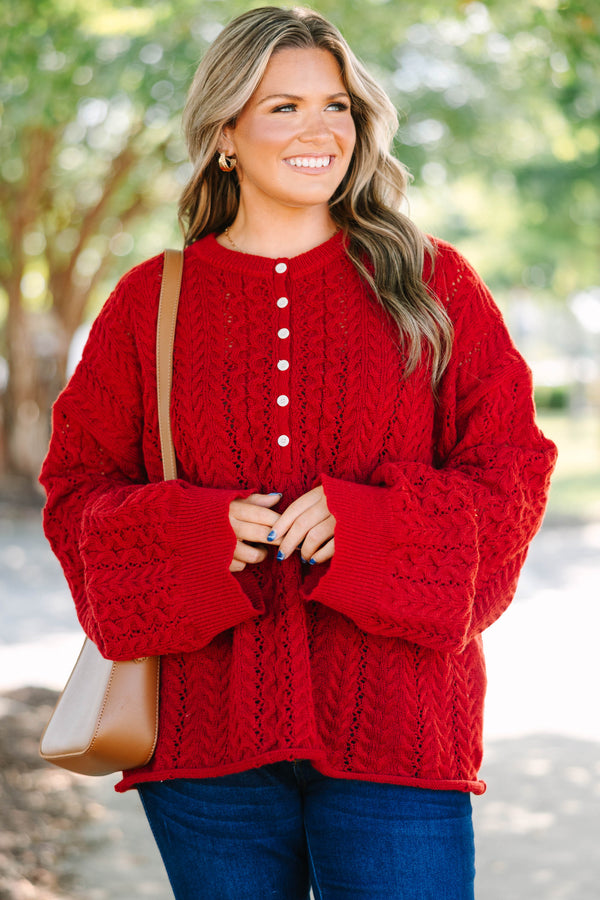 Plus size deep red cable knit sweater with a flowy fit, button-up neckline, and wide sleeves.