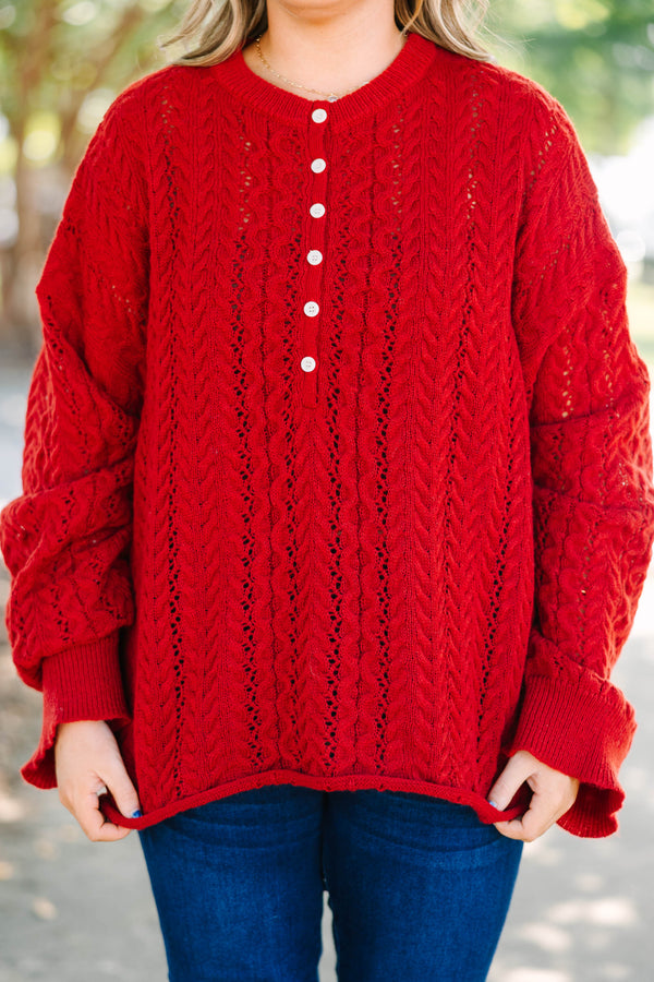 Plus size deep red cable knit sweater with a flowy fit, button-up neckline, and wide sleeves.