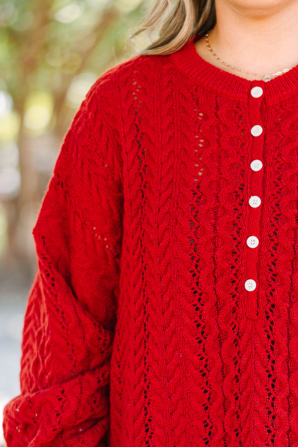 Plus size deep red cable knit sweater with a flowy fit, button-up neckline, and wide sleeves.