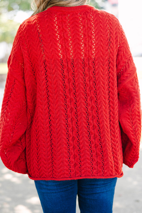Plus size deep red cable knit sweater with a flowy fit, button-up neckline, and wide sleeves.