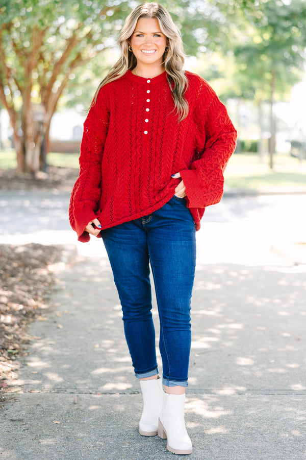 Plus size deep red cable knit sweater with a flowy fit, button-up neckline, and wide sleeves.