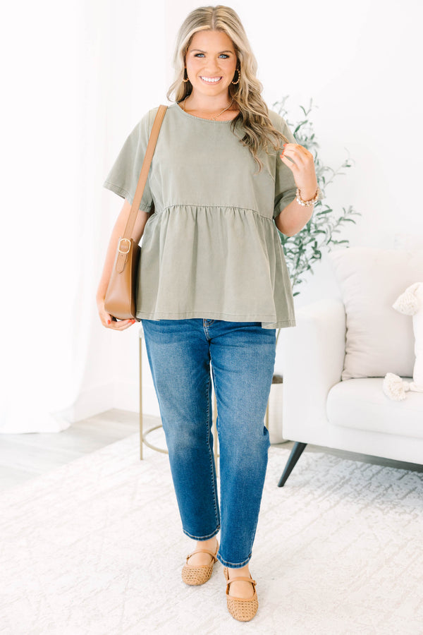 Plus Size olive green short sleeve babydoll top with a round neckline and ruffled waist seam.