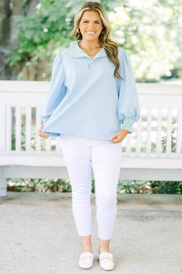Plus size top in light blue with striped ruffle collar and smocked cuffs.