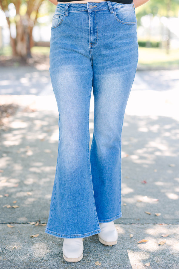 Plus Size medium wash flare jeans with a high-waisted fit and classic five-pocket styling.