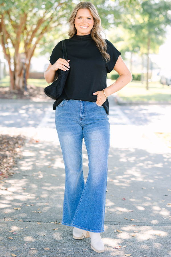 Plus Size medium wash flare jeans with a high-waisted fit and classic five-pocket styling.