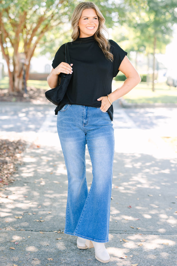 Plus Size medium wash flare jeans with a high-waisted fit and classic five-pocket styling.