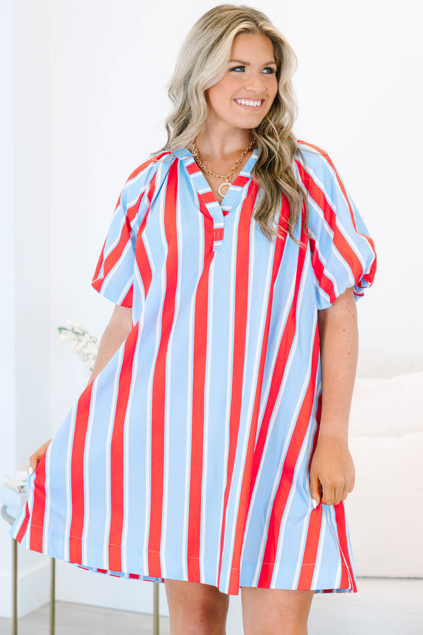 Plus size blue and red vertical striped shift dress with puff sleeves and a v-neckline.