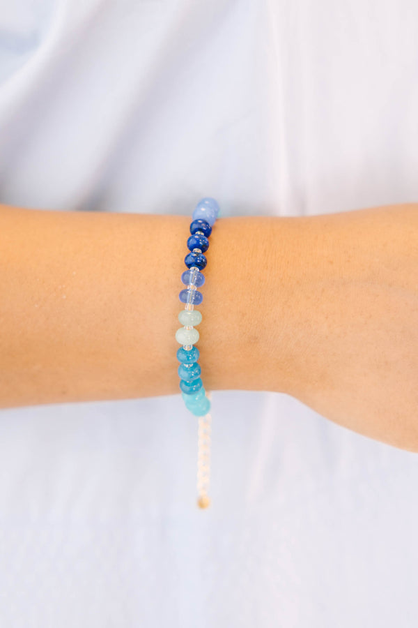 Plus Size Shoreline Shimmer Bracelet with a gradient of blue, teal, and white beads.