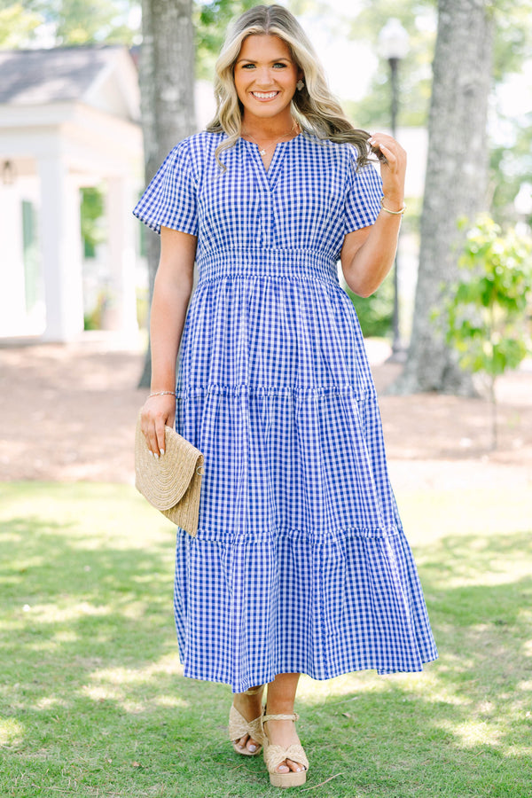 Plus size navy blue gingham midi dress with a smocked waist, V-neckline, and tiered flowy skirt.