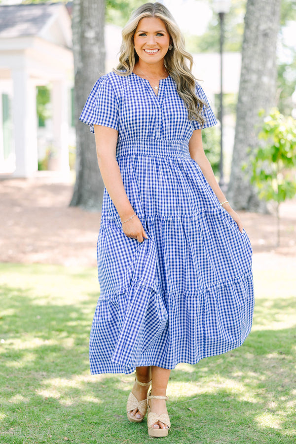 Plus size navy blue gingham midi dress with a smocked waist, V-neckline, and tiered flowy skirt.