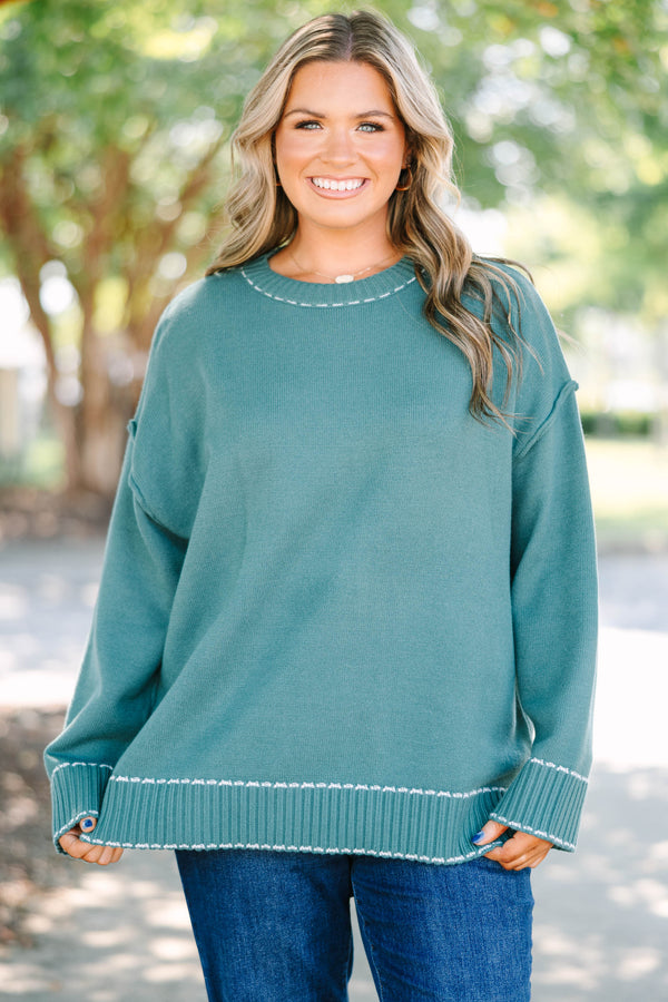 Plus Size green knit crewneck sweater with white contrast stitching on the neckline and ribbed hem.